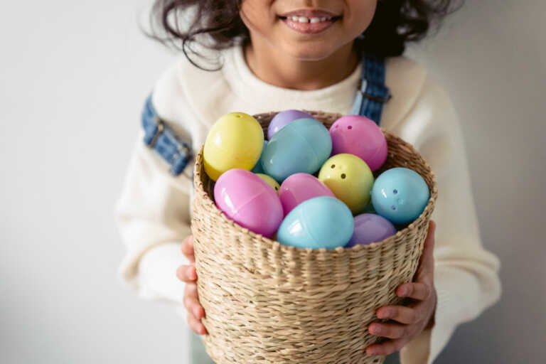 girl holding basket of Easter eggs